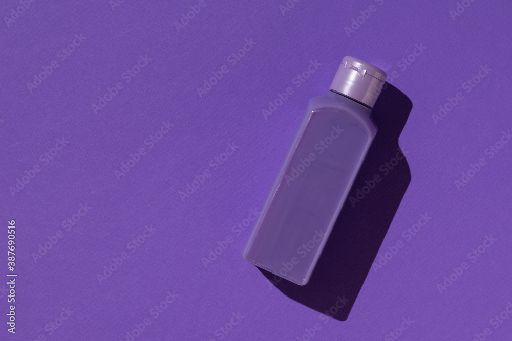 Monochrome image of a purple bottle on a purple background. Monochrome image of a purple bottle on a purple background.