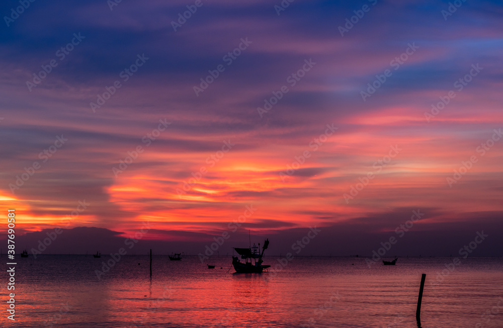 Fishing boat with sunset on the beach in Thailand