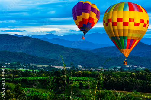 Colorful hot air balloons flying over mountain at  pai mae hong son Thailand. © Meawstory15Studio