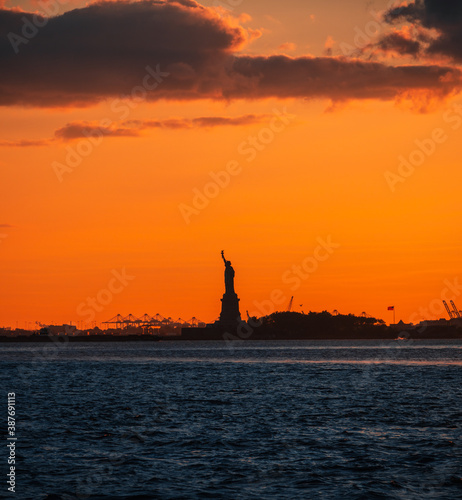 silhouette statued of liberty New York sky orange sunset sea 