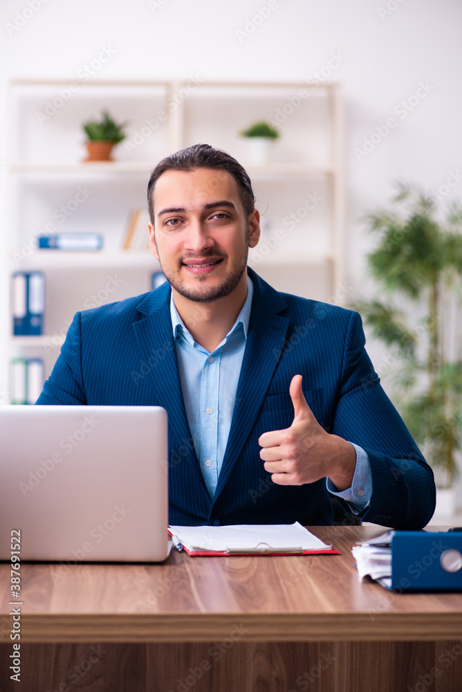 Obraz premium Young male businessman employee working in the office