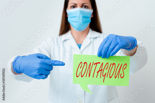 Text sign showing Contagious. Business photo text transmissible by direct or indirect contact with infected an individual Laboratory technician featuring empty sticker paper accessories smartphone photo