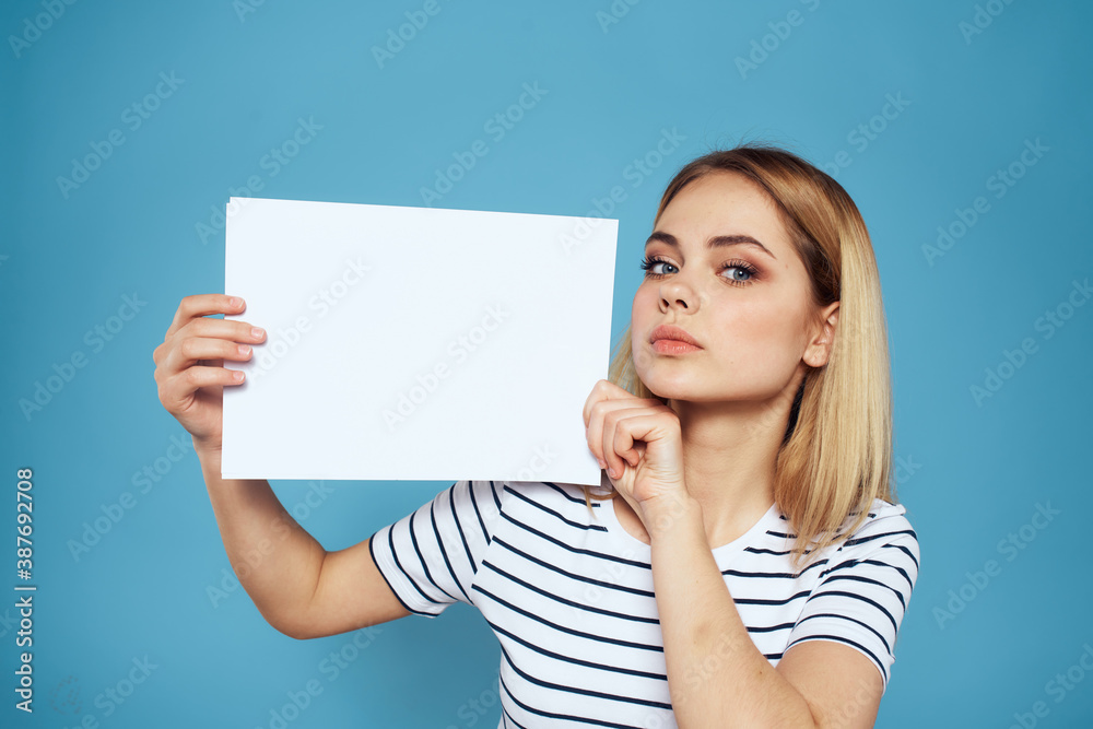 Woman holding sheet of paper striped T-shirt Copy Space cropped view blue background Woman holding sheet of paper striped T-shirt Copy Space cropped view blue background