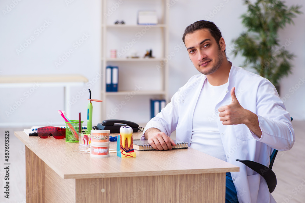 Young male dentist working in the clinic Young male dentist working in the clinic