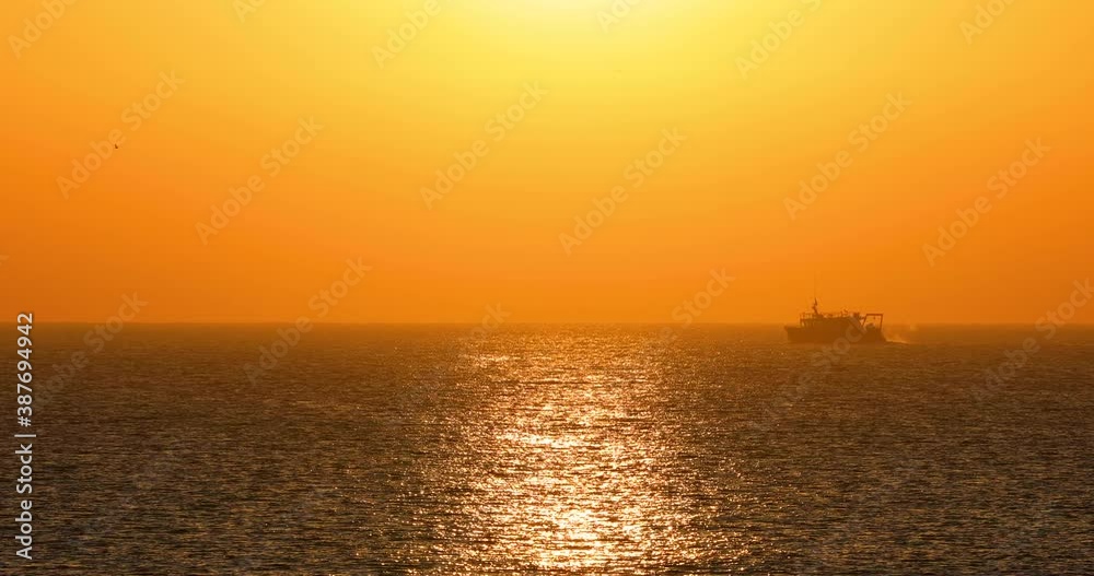 Ocean sunrise. Sailing boat in sea ripple waves Ocean sunrise. Sailing boat in sea ripple waves