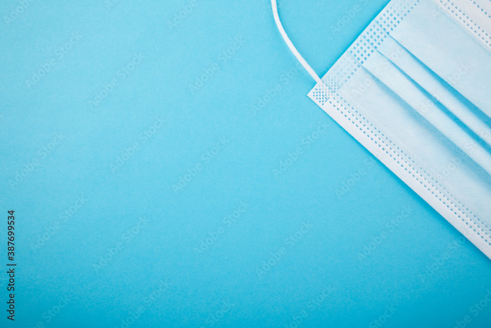 Blank blue background with mask aside Blank blue background with mask aside