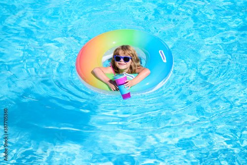 Child in swimming pool. Summer kids cocktail party. Summer beach fun.