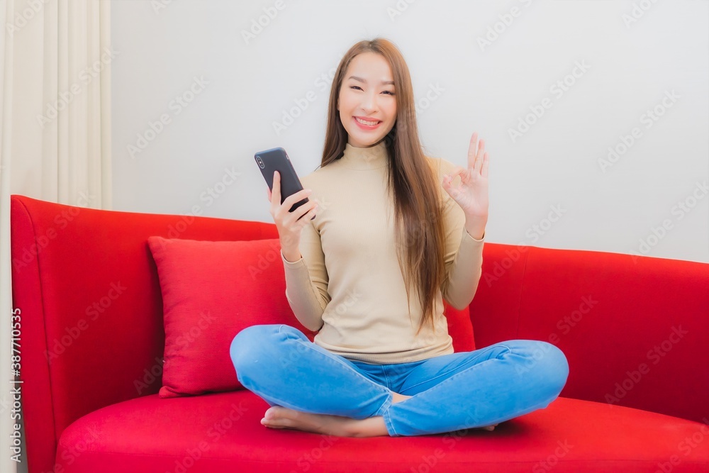 Portrait beautiful young asian woman use smart mobile phone on sofa Portrait beautiful young asian woman use smart mobile phone on sofa