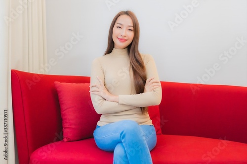Portrait beautiful young asian woman smile relax on sofa