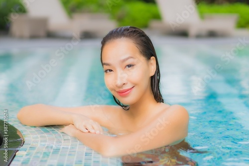 Portrait beautiful young asian woman relax smile around outdoor swimming pool