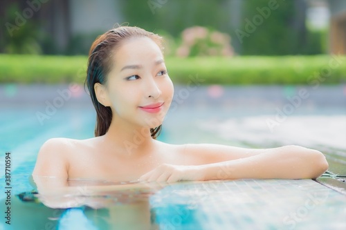 Portrait beautiful young asian woman relax smile around outdoor swimming pool © siraphol