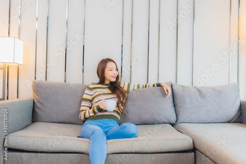 Portrait beautiful young asian woman smile relax on sofa