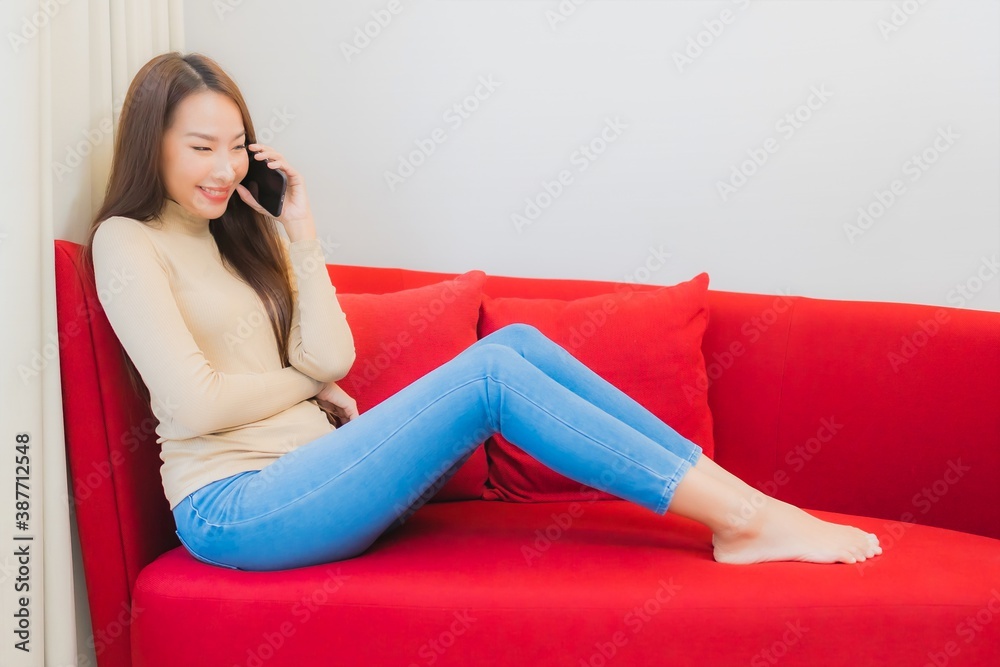 Portrait beautiful young asian woman use smart mobile phone on sofa Portrait beautiful young asian woman use smart mobile phone on sofa