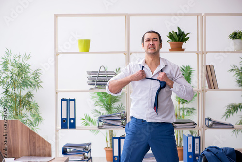 Young male employee businessman at workplace