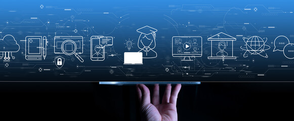 Distance learning concept with hand using a digital tablet computer on grey blue background.