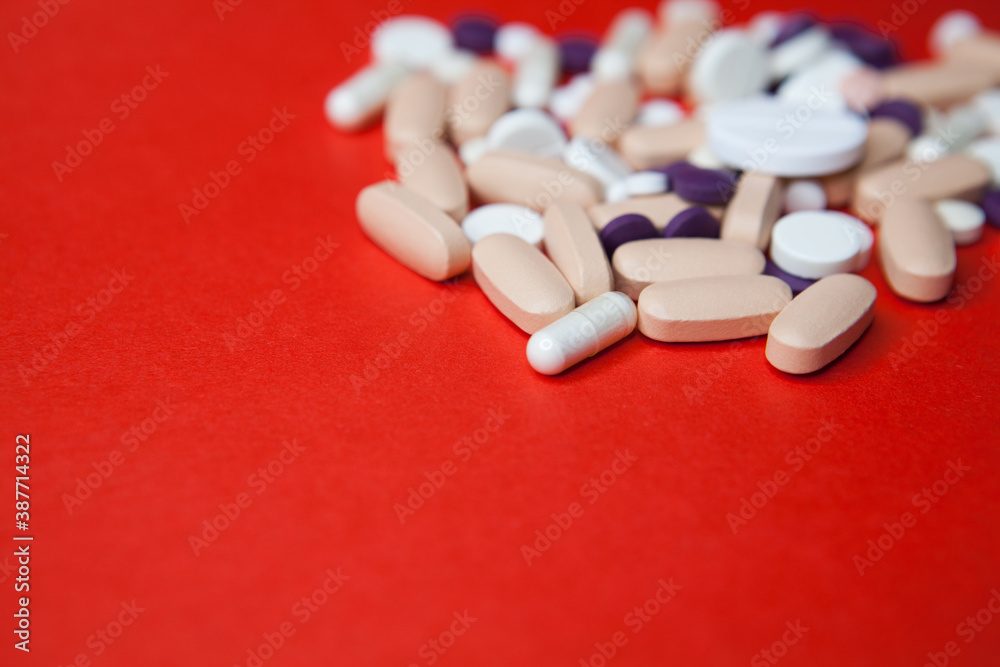 Various pills macro on red background. Top view Various pills macro on red background. Top view