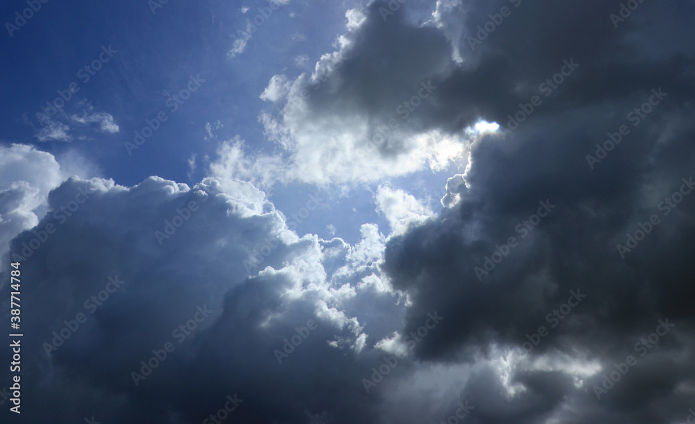 Noon sky  with dark clouds IN front of blue sky