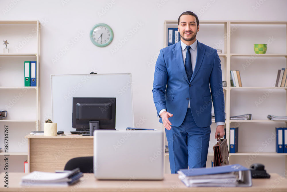 Young male businessman employee working in the office