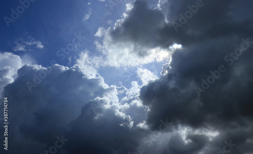 Noon sky with dark clouds IN front of blue sky