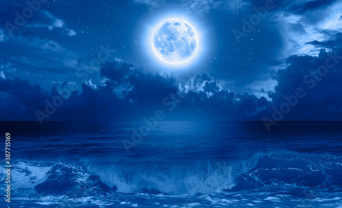 Night sky with blue moon in the clouds  Elements of this image furnished by NASA