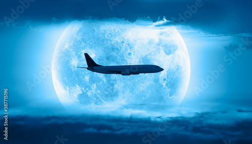 Fototapeta Naklejka Na Ścianę i Meble -  Passenger airplane in the sky on the background full moon at sunset 
