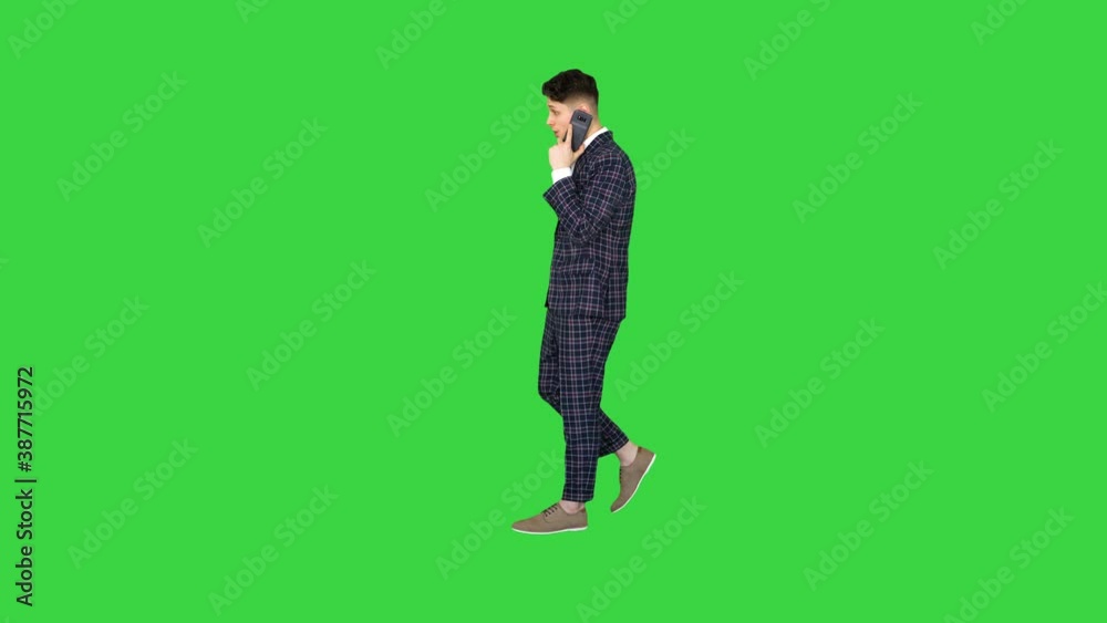 Inspired man in formal receiving good news on the phone and dancing after on a Green Screen, Chroma Key.