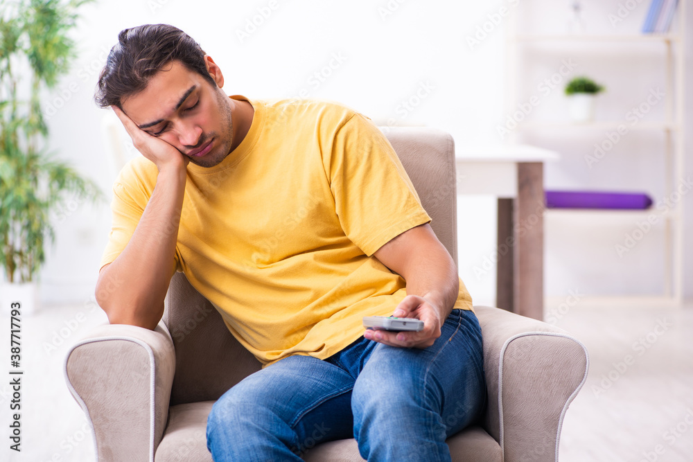 Young man watching tv at home Young man watching tv at home