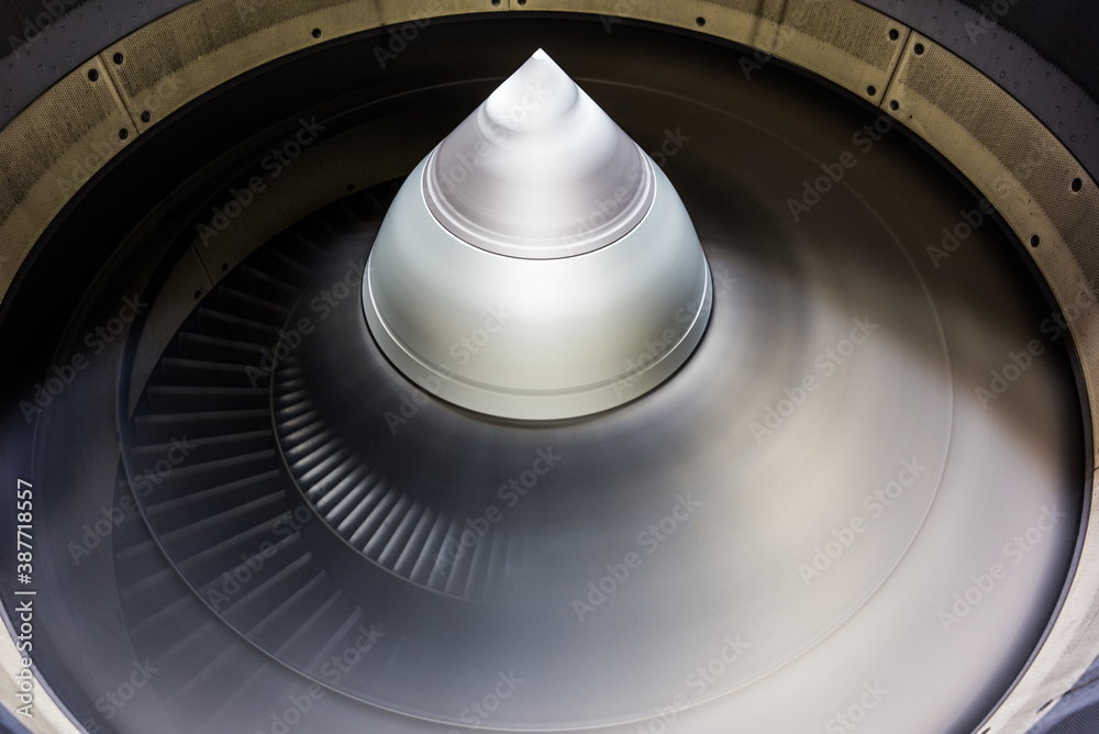 Fototapeta premium running jet engine turbine with fast turning fan blades - close-up