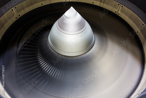 running jet engine turbine with fast turning fan blades - close-up
