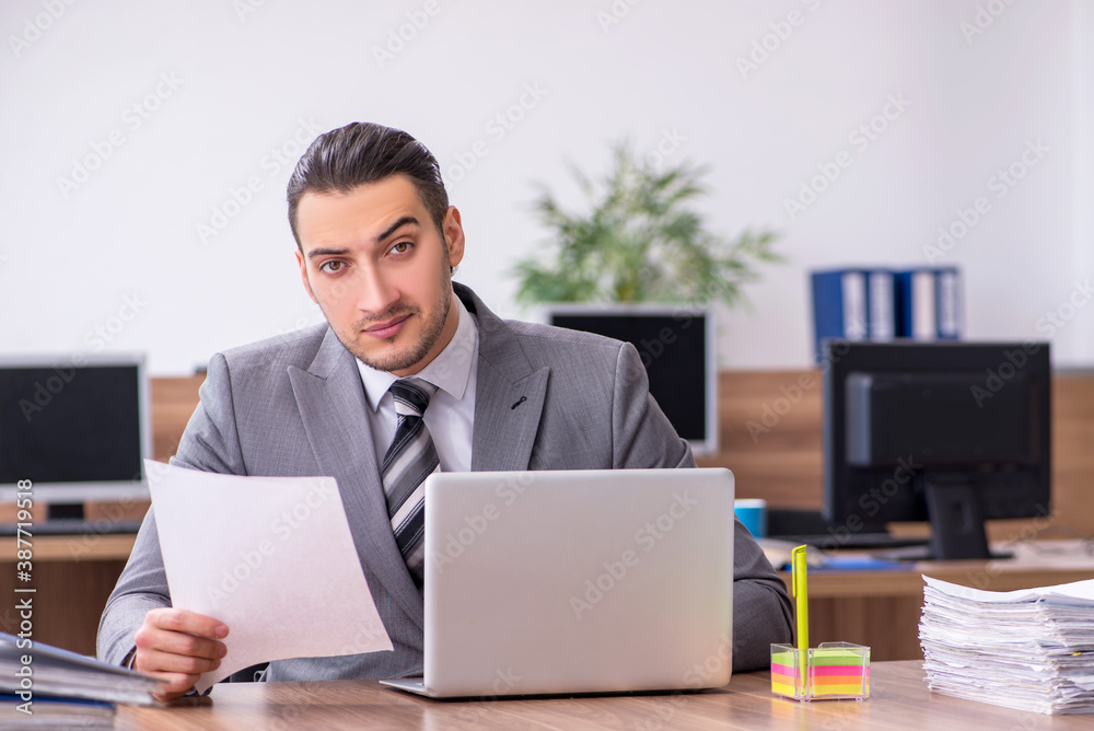 Young male employee working in the office Young male employee working in the office