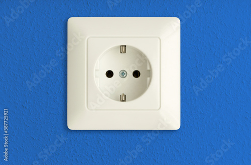 electrical power socket on bright blue wall, electric power outlet, european standard