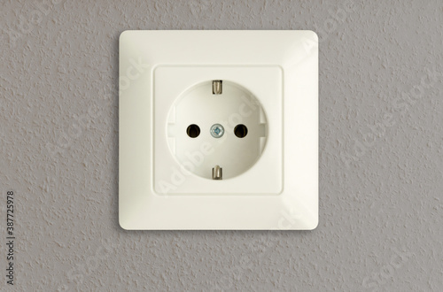 electrical power outlet on gray wall, european standard, power socket