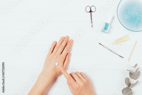 Woman s hands apply cosmetic skin care cream