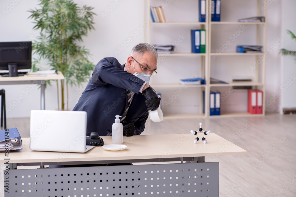 Old male boss employee working during pandemic Old male boss employee working during pandemic