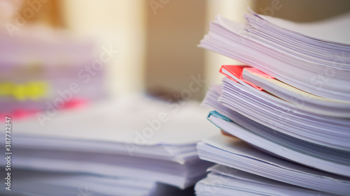 Stack of Education report in school, Class documents of Binders file Paperwork folder on teacher desk in university