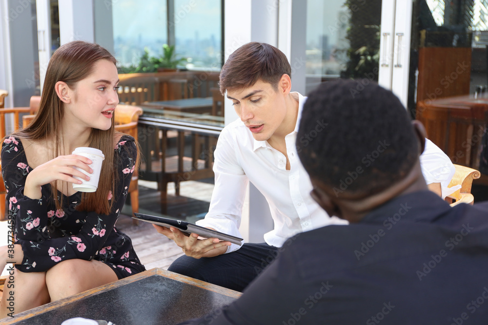 Fototapeta premium Young teen business people enjoy meeting and talking with team or friends or coworker by using tablet and relax drinking coffee break