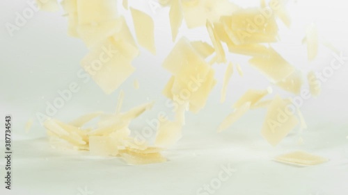 Super Slow Motion Shot of Parmesan Shavings Falling on White Background at 1000 fps. photo