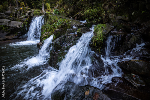 Rapid mountain river with a waterfall in the national park