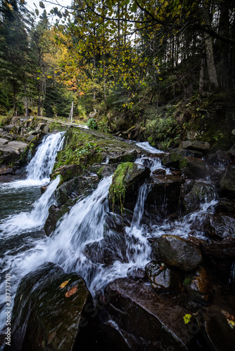 Rapid mountain river with a waterfall in the national park