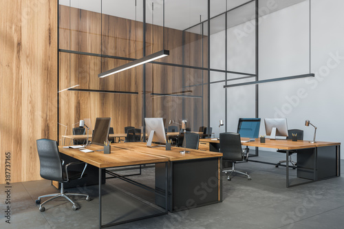 Wooden office tables with computers view on the city, open space office room © ImageFlow