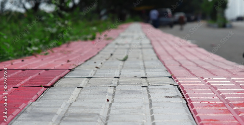 pattern board empty tiles in front of blurred background. Perspective red and brown tile over blur footpath - we can be used for display or montage your products.Mock up for display of product.