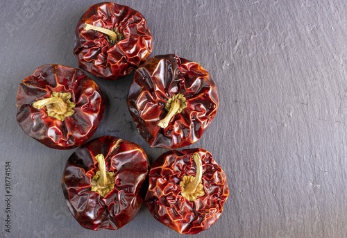 Spanish dried ñora nyora pepper on gray background, natural light, close up, top view photo