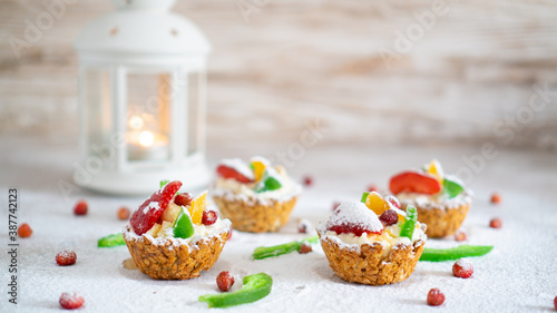 Healthy homemade sweet cakes with cottage cheese, fresh fruits and powdered sugar arround. White New Year background