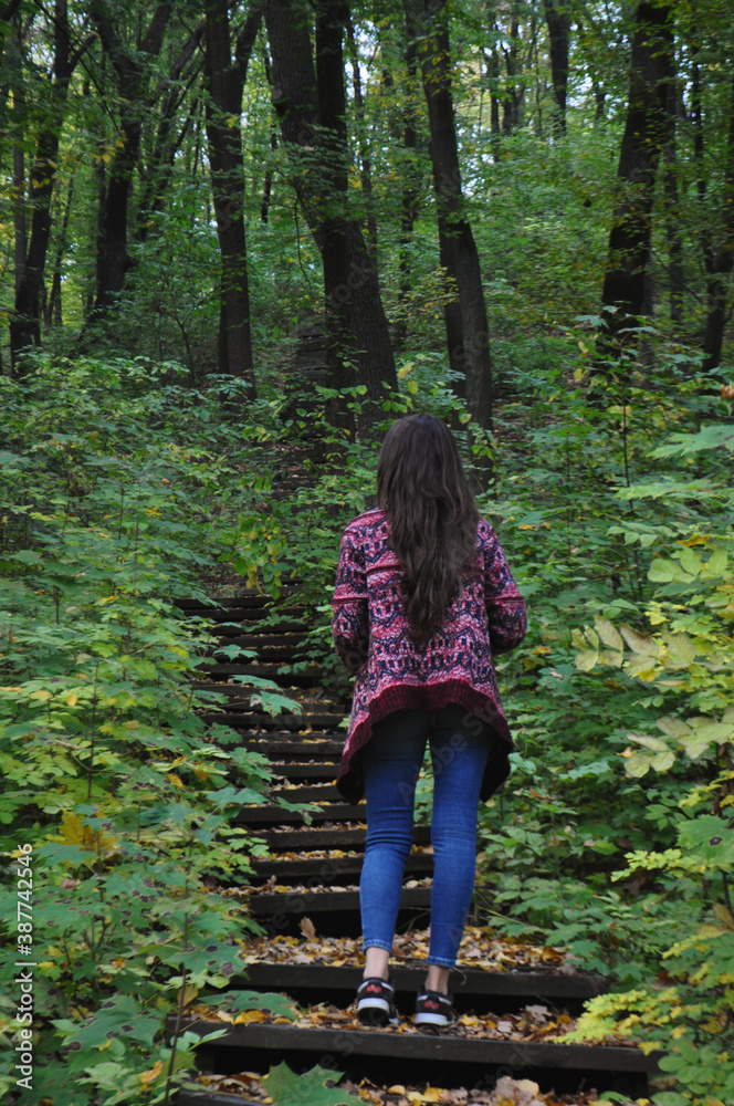 woman walking in the woods woman walking in the woods