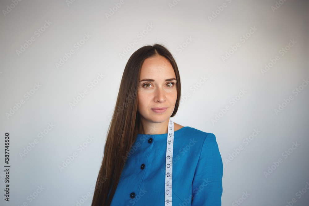 portrait of a young beautiful seamstress in blue dress portrait of a young beautiful seamstress in blue dress