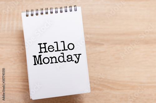 White notebook with text "Hello Monday". Symbol for starting a new week.
