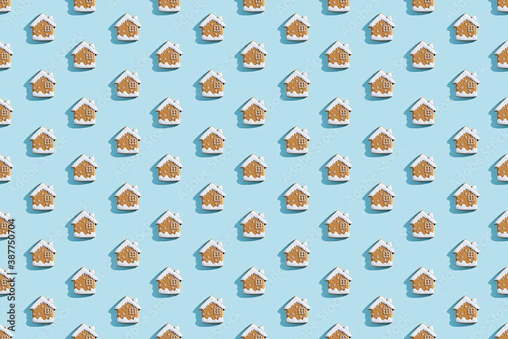 Naklejka premium Christmas bakery. Festive food pattern. Homemade cookies. Gingerbread biscuit house figures with white icing isolated on blue pastel.