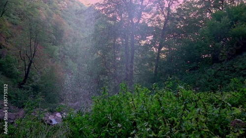 High cliff waterfall Vanturatoarea, Romania. Slow motion
 photo