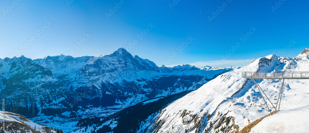 Winter landscape with snow covered peaks seen from the First mountain in Swiss Alps in Grindelwald, Switzerland