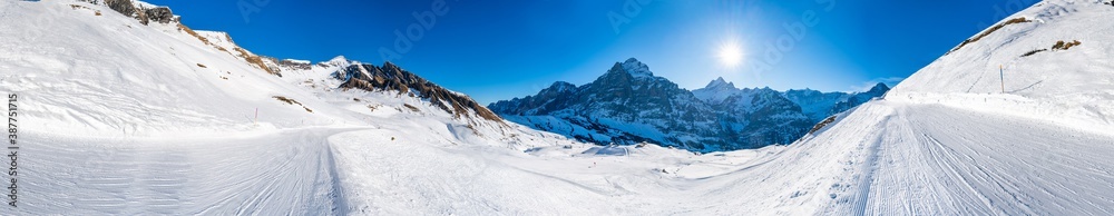 360 degree panoramic winter landscape with snow covered peaks seen from the First mountain in Swiss Alps in Grindelwald, Switzerland